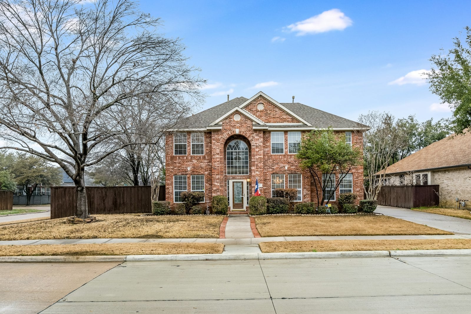 Two-story brick house with a large front yard